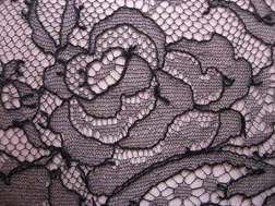 a detail of the lace on Louboutin's lace overlay clutch for fall 06